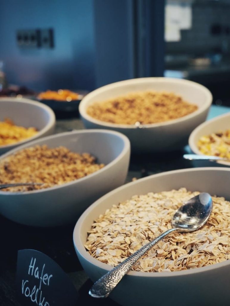 Nahaufnahme von verschiedenen Cerealien in Schalen am Frühstücksbuffet.